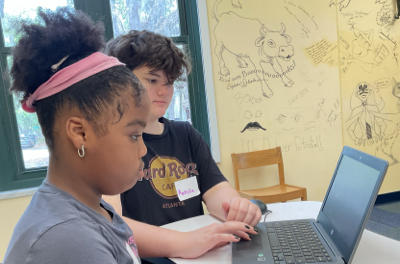 Assistant Instructor Aurelia explaining CSS layout properties to a Girls Code Savannah beginner student